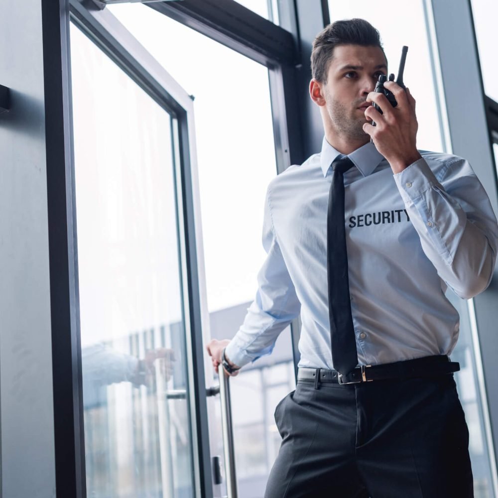 handsome-guard-in-suit-talking-on-walkie-talkie-RTAA98L.jpg